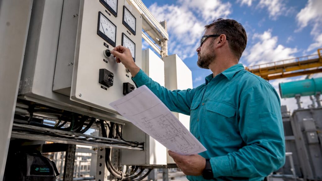 Engineer inspecting ATS control panel
